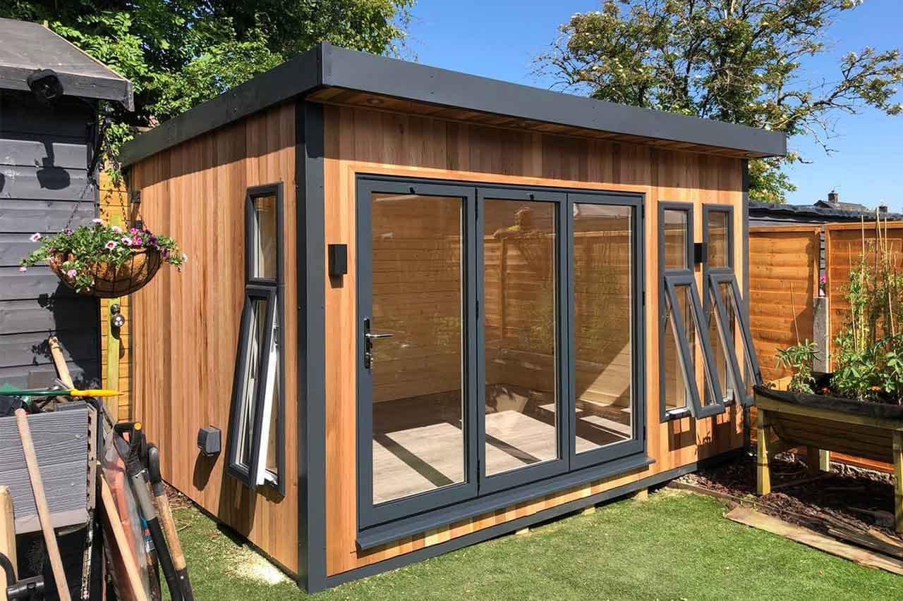 Cedar-clad garden room with bifold doors built by Peninsula Premier Construction