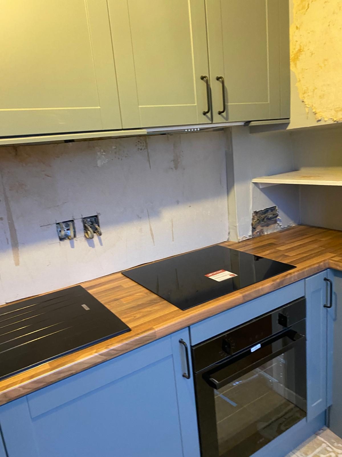 Blue kitchen with solid oak worktops and white wall units