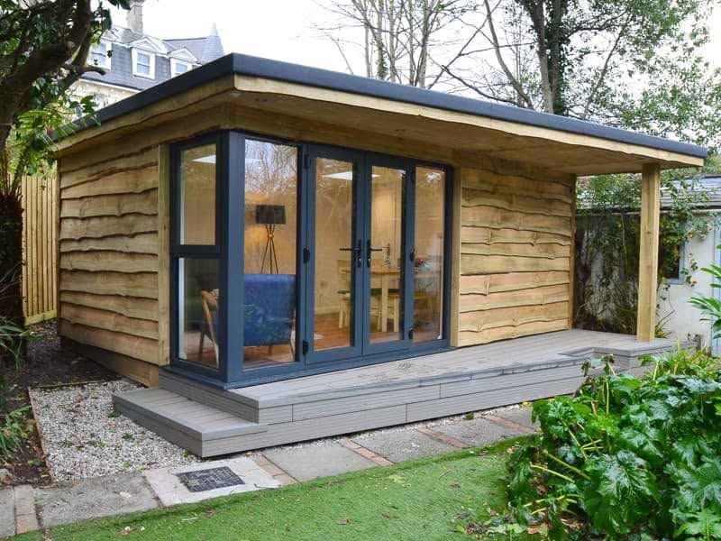 Wavy-edge cedar clad garden room with deck